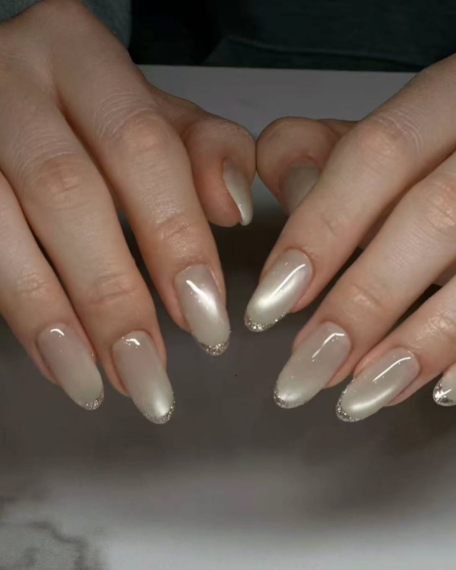 Pearl champagne chrome nails with a glossy finish