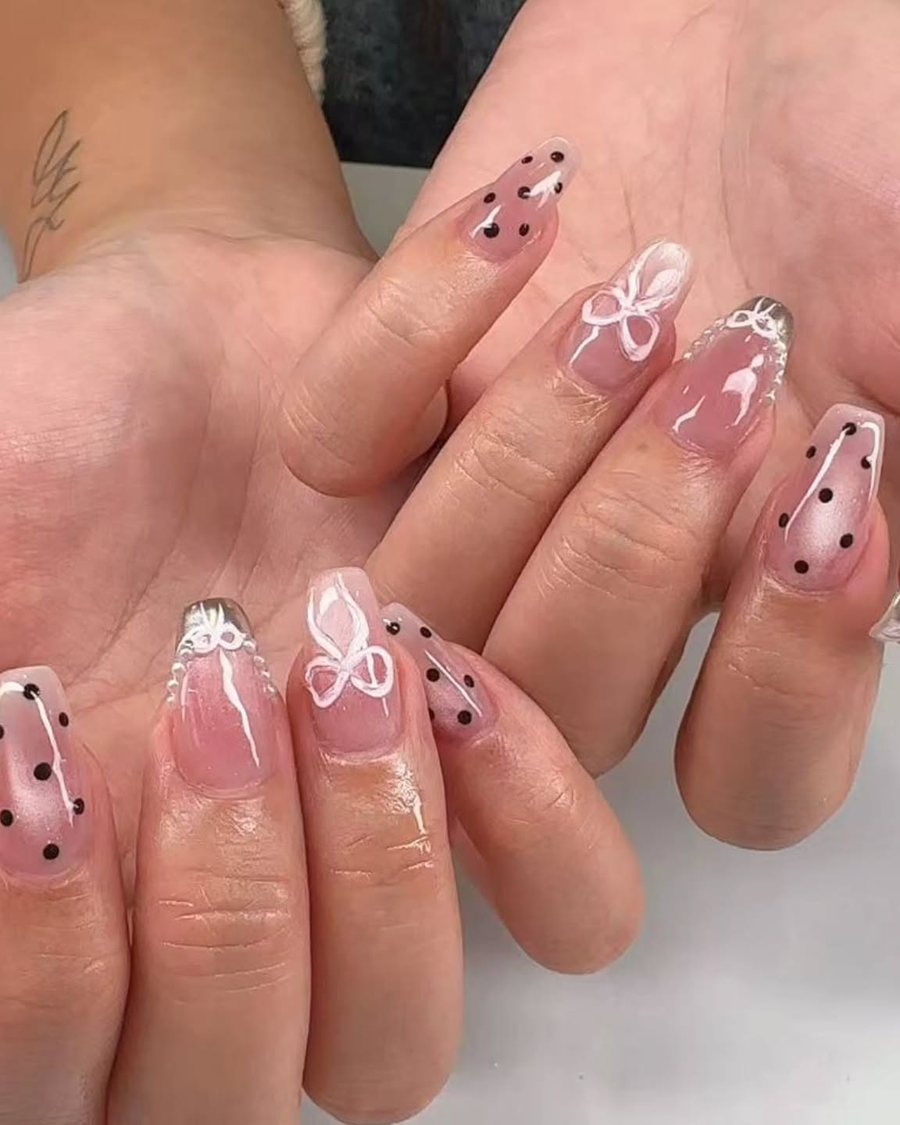 Blush nails with fine bow and dot detailing