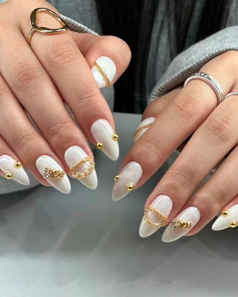 Ivory almond nails with small gold studs